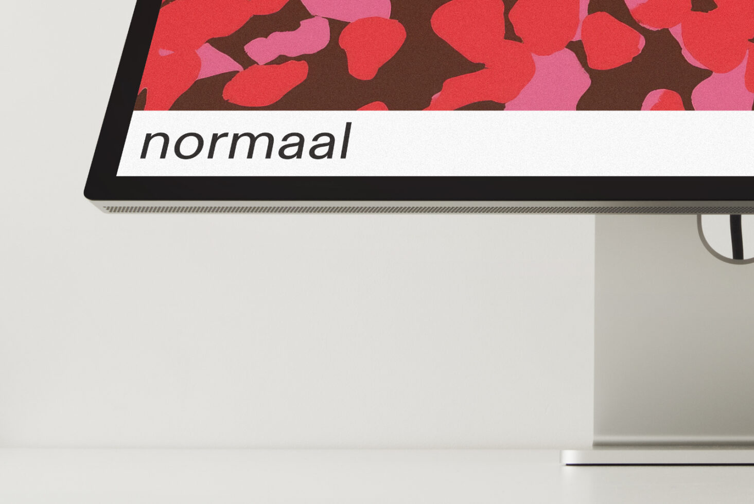 Monitor displaying colorful blob pattern design with normaal typography label below