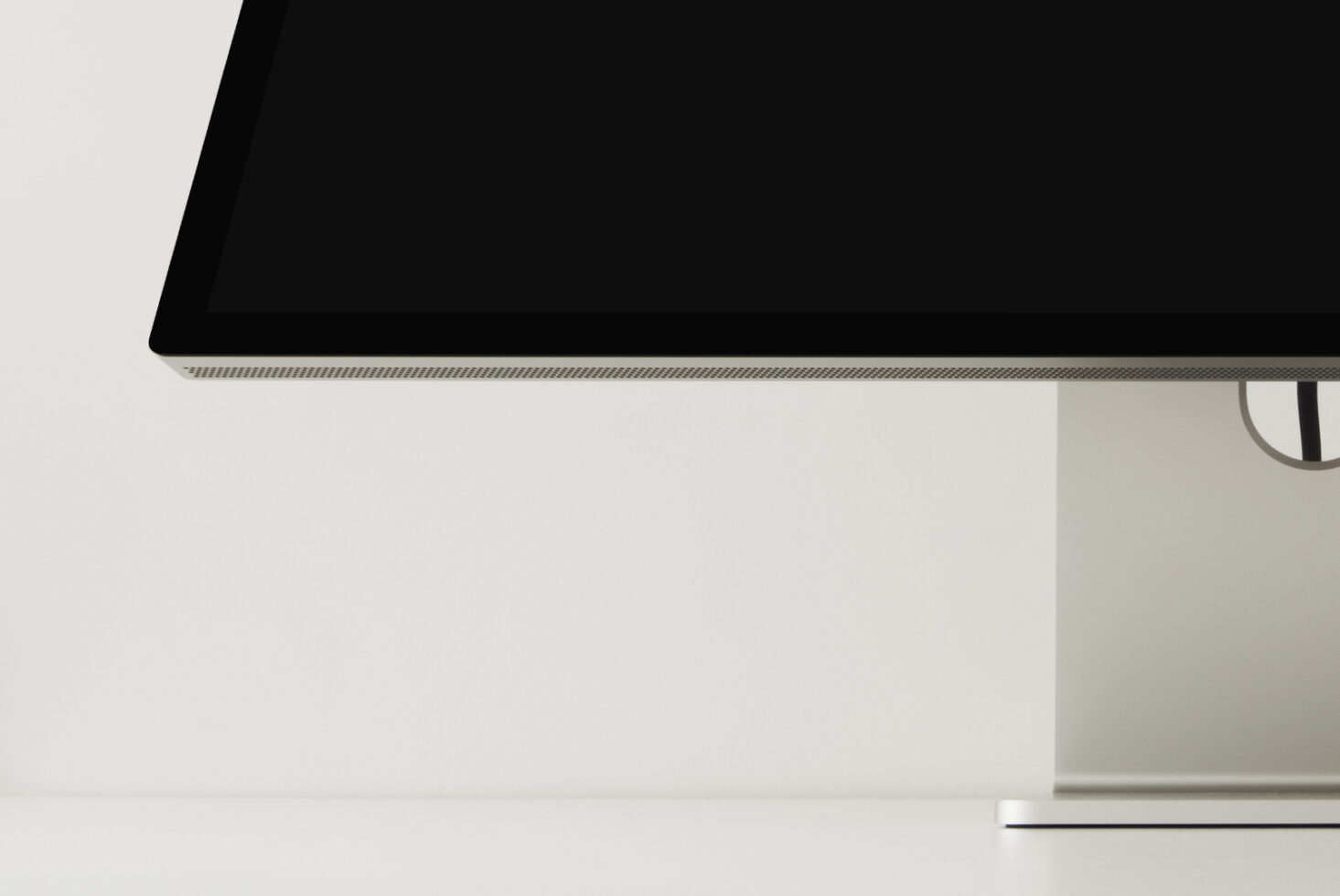 Close-up of monitor bezel with empty black screen against neutral background
