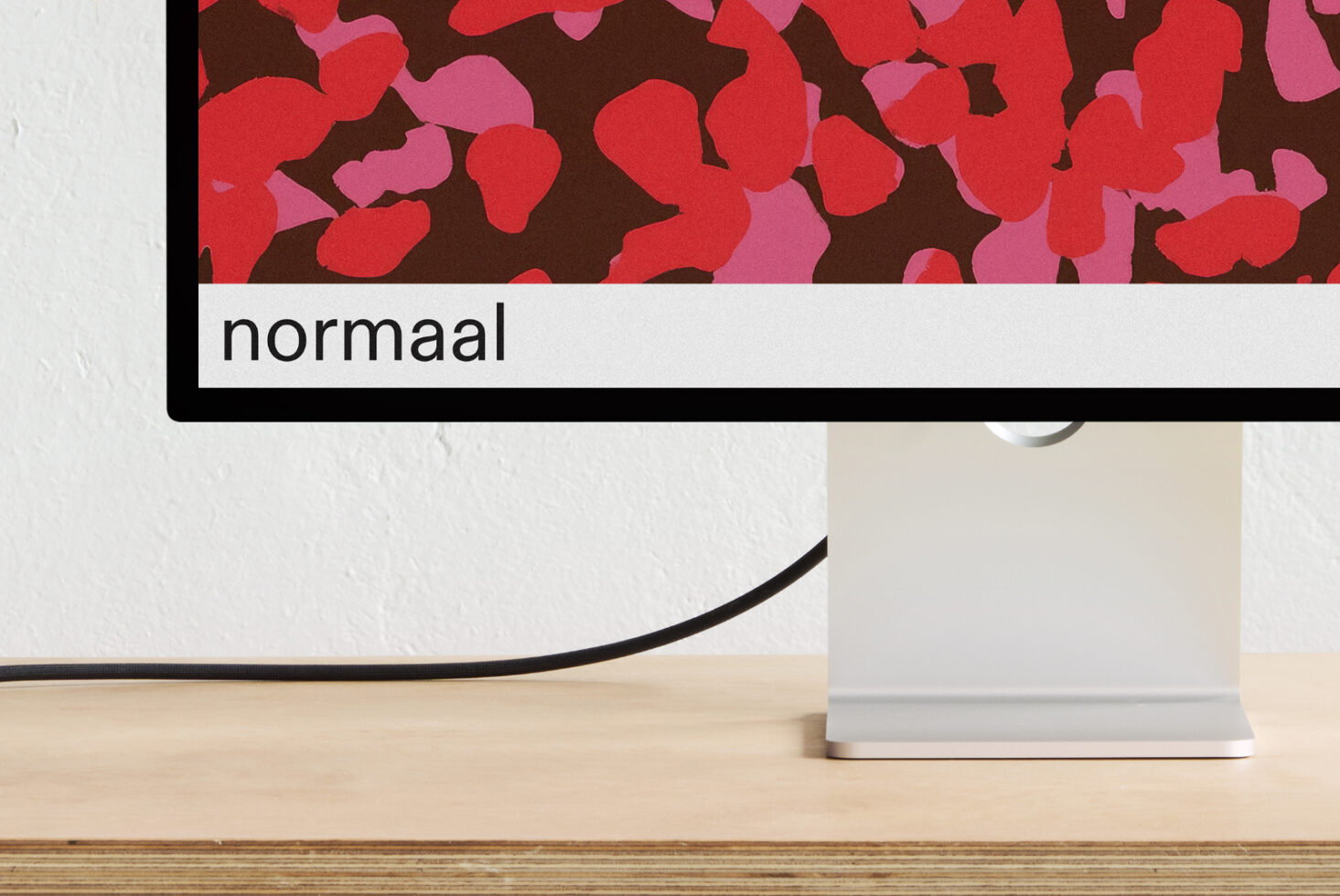 Monitor screen showing red organic blob pattern with normaal text label