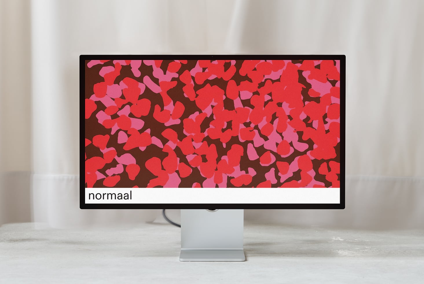 Monitor mockup displaying colorful floral pattern with normaal label below