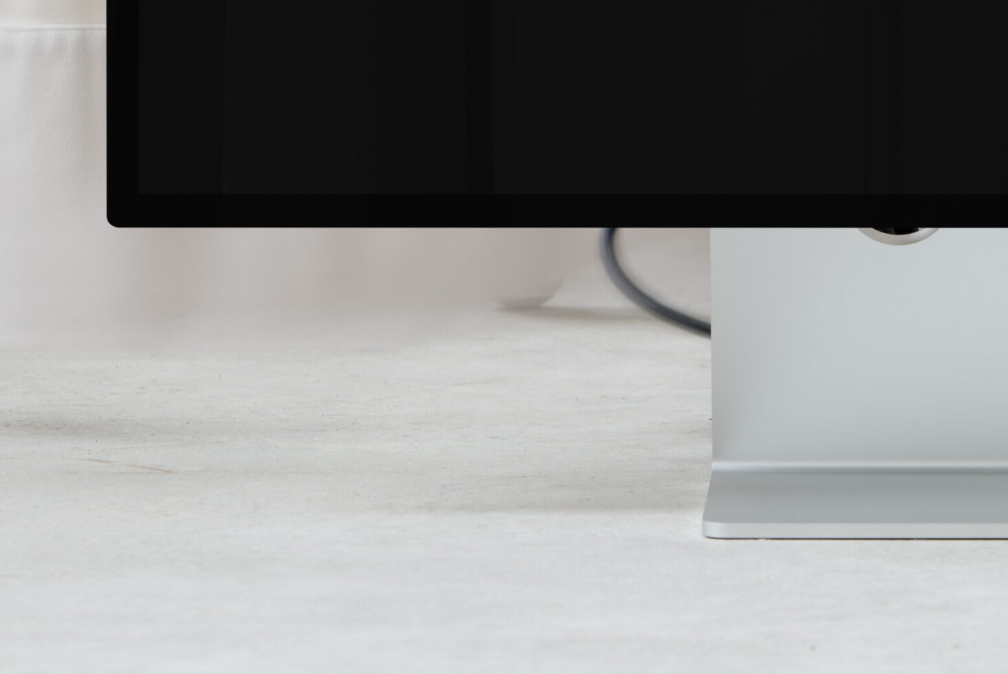 Desktop monitor mockup from overhead angle on white wooden desk