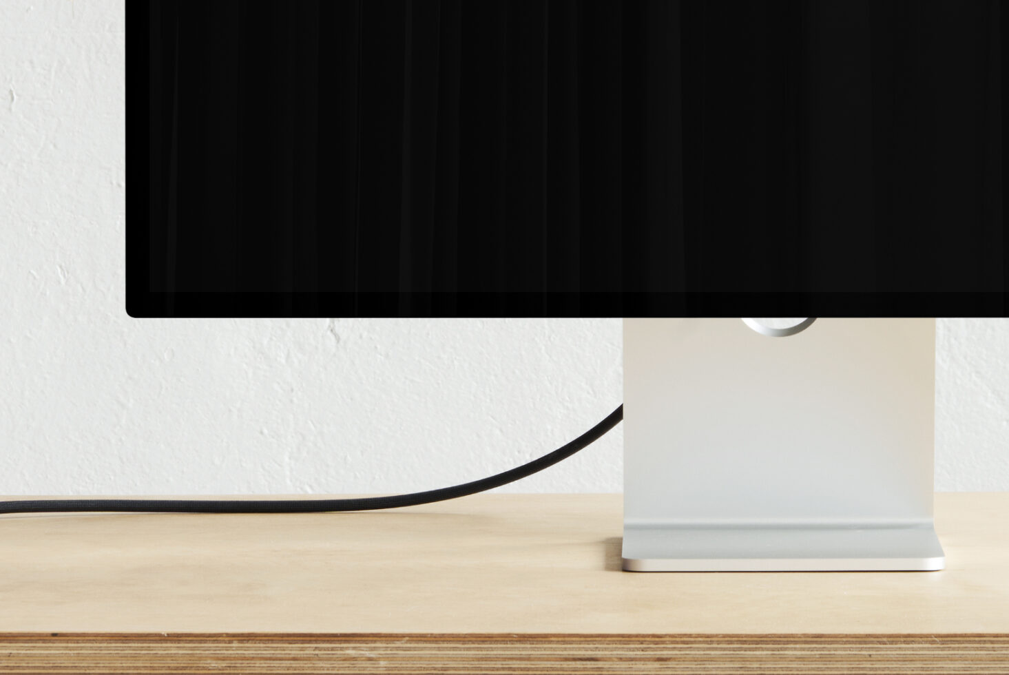 Desktop monitor mockup on wooden desk with white wall background