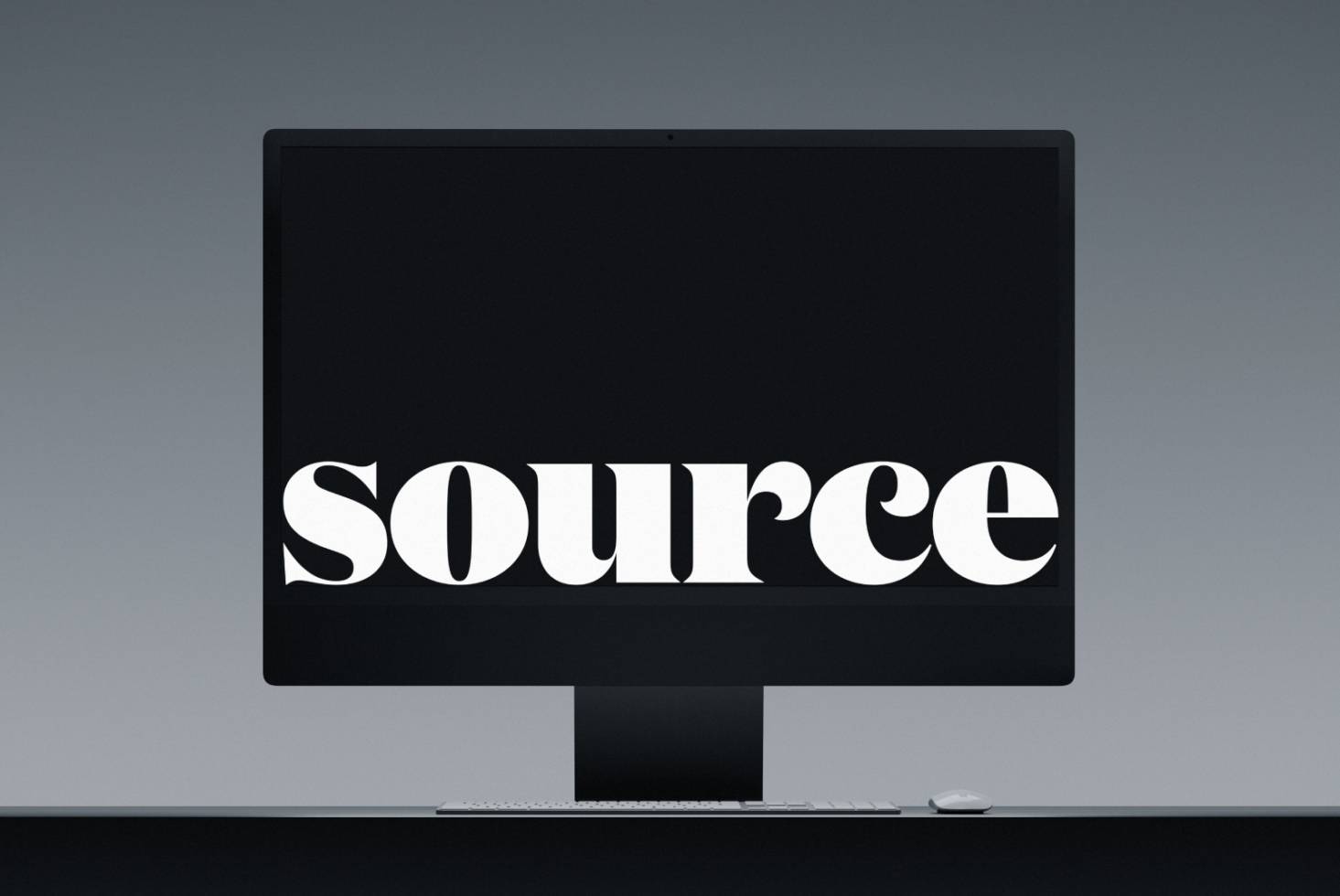 Desktop monitor mockup with keyboard, mouse displaying white serif text on black