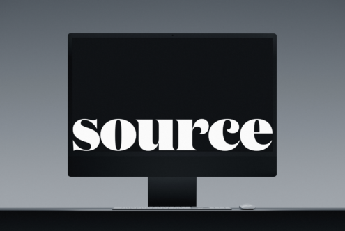 Desktop monitor mockup with keyboard, mouse displaying white serif text on black