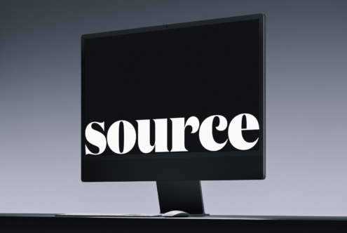 Desktop monitor mockup displaying source word on black screen