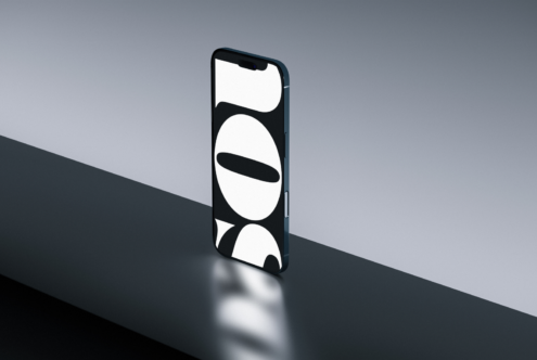 Smartphone displaying minimalist circular shapes on black background