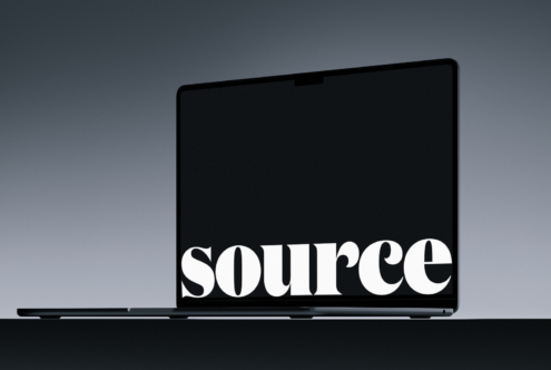 Laptop mockup with bold serif text centered on dark screen