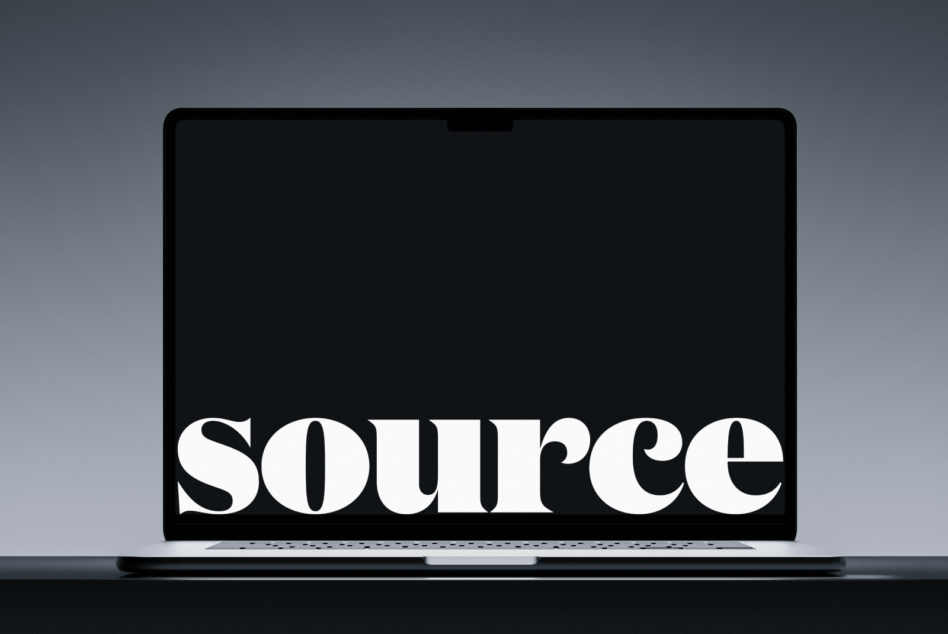Laptop closed showing white serif text on black screen against gray surface
