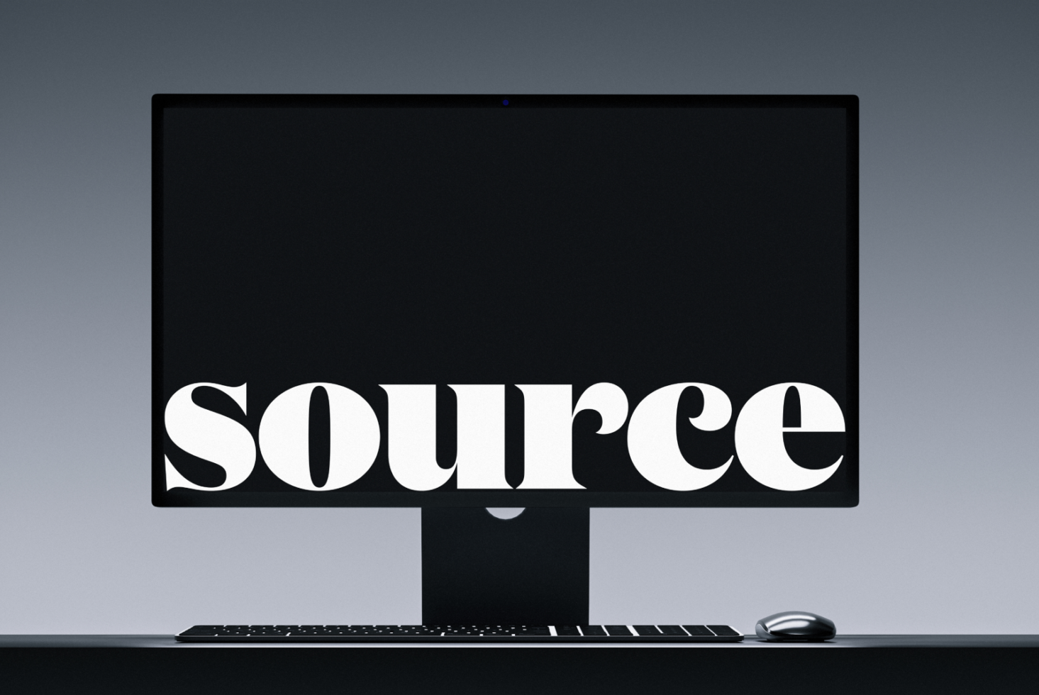 Desktop monitor with keyboard showing white serif typography on black screen
