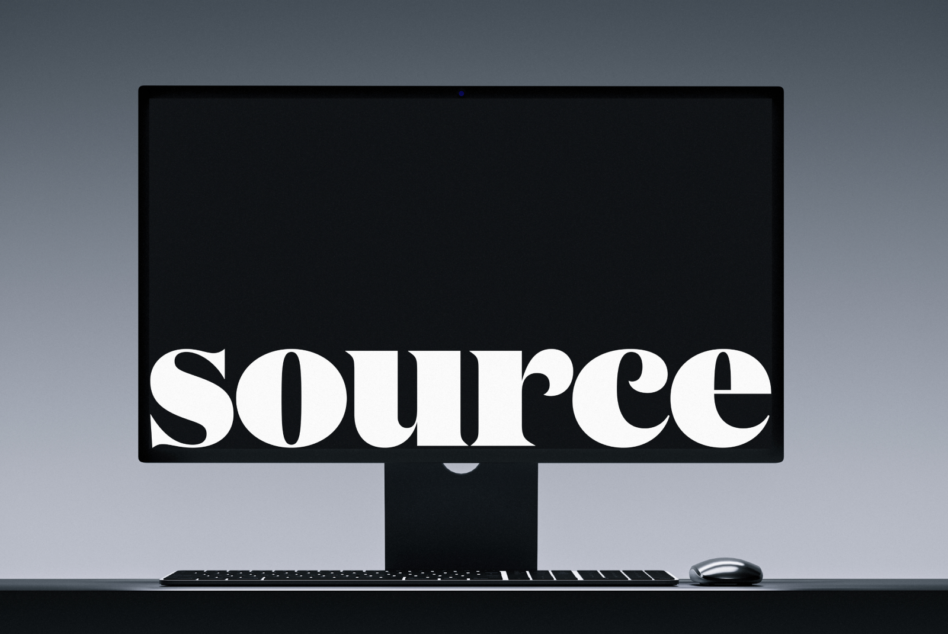 Desktop monitor with keyboard showing white serif typography on black screen