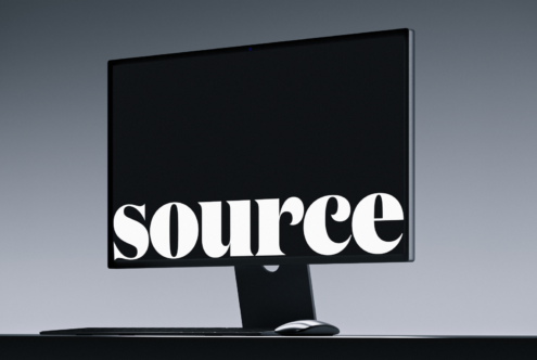 Desktop monitor mockup with serif text on dark background