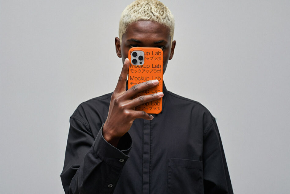 iPhone 12 Pro case mockup in bright orange held by person with blonde hair wearing black