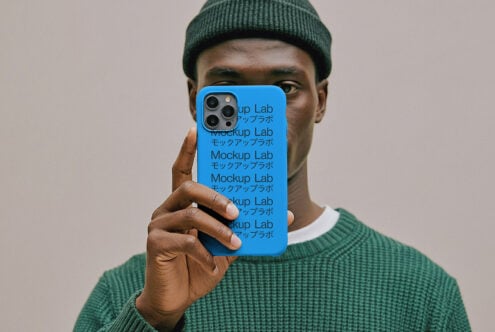 iPhone 12 Pro case mockup in bright blue with rounded edges held by person in green sweater