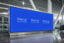Bright blue digital billboard in modern airport terminal showing Mockup Lab branding