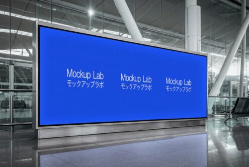 Bright blue digital billboard in modern airport terminal showing Mockup Lab branding