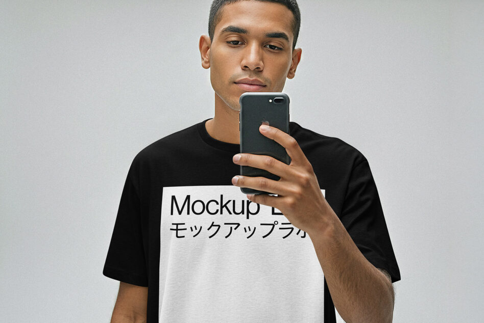 Guy in black tee with white chest print holding black phone to face