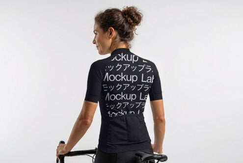 Woman on bike wearing black cycling jersey mockup rear view