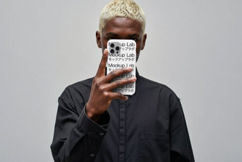 iPhone 12 Pro case mockup in white held by person with blonde hair in black shirt