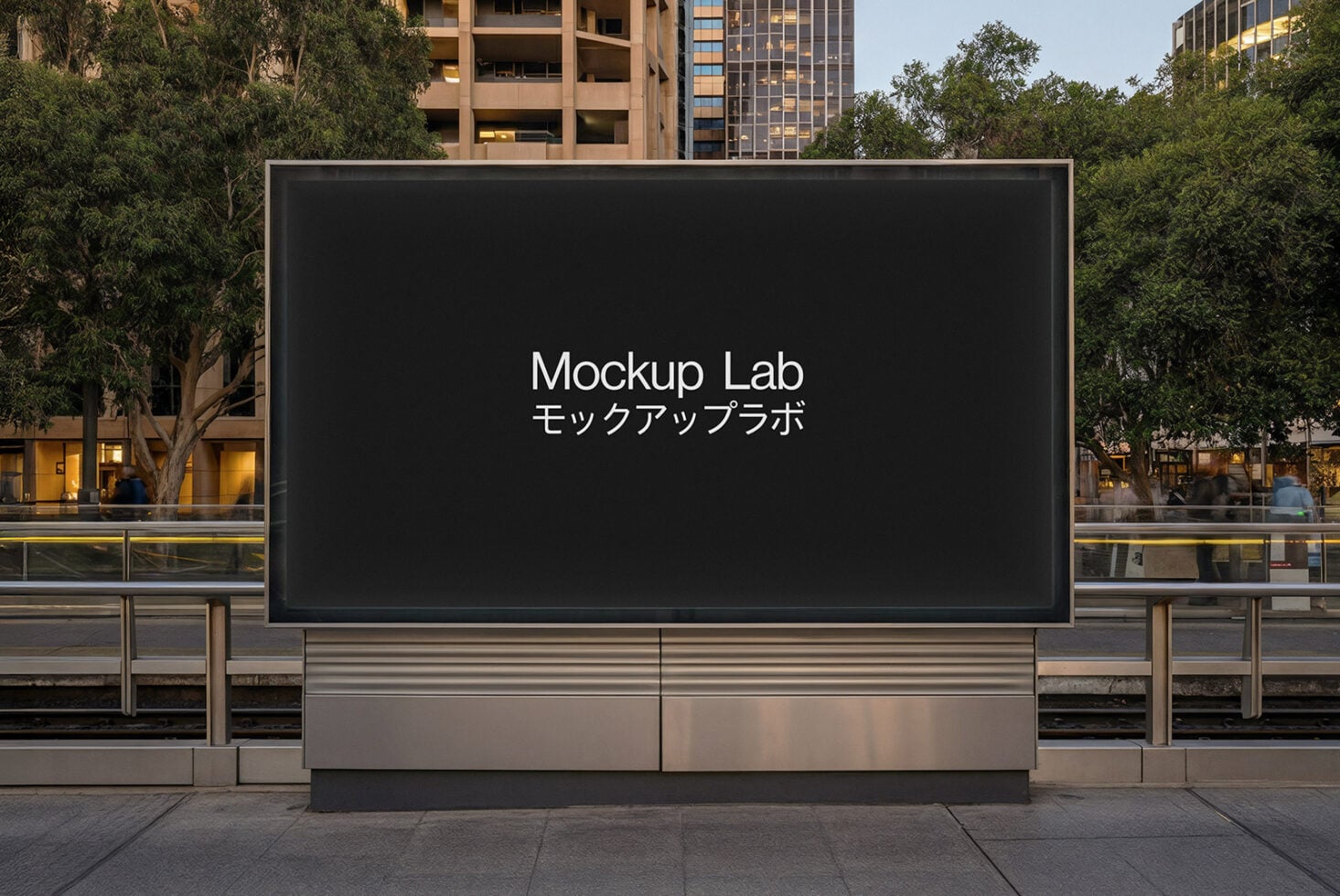 Black digital billboard in public plaza surrounded by city buildings trees
