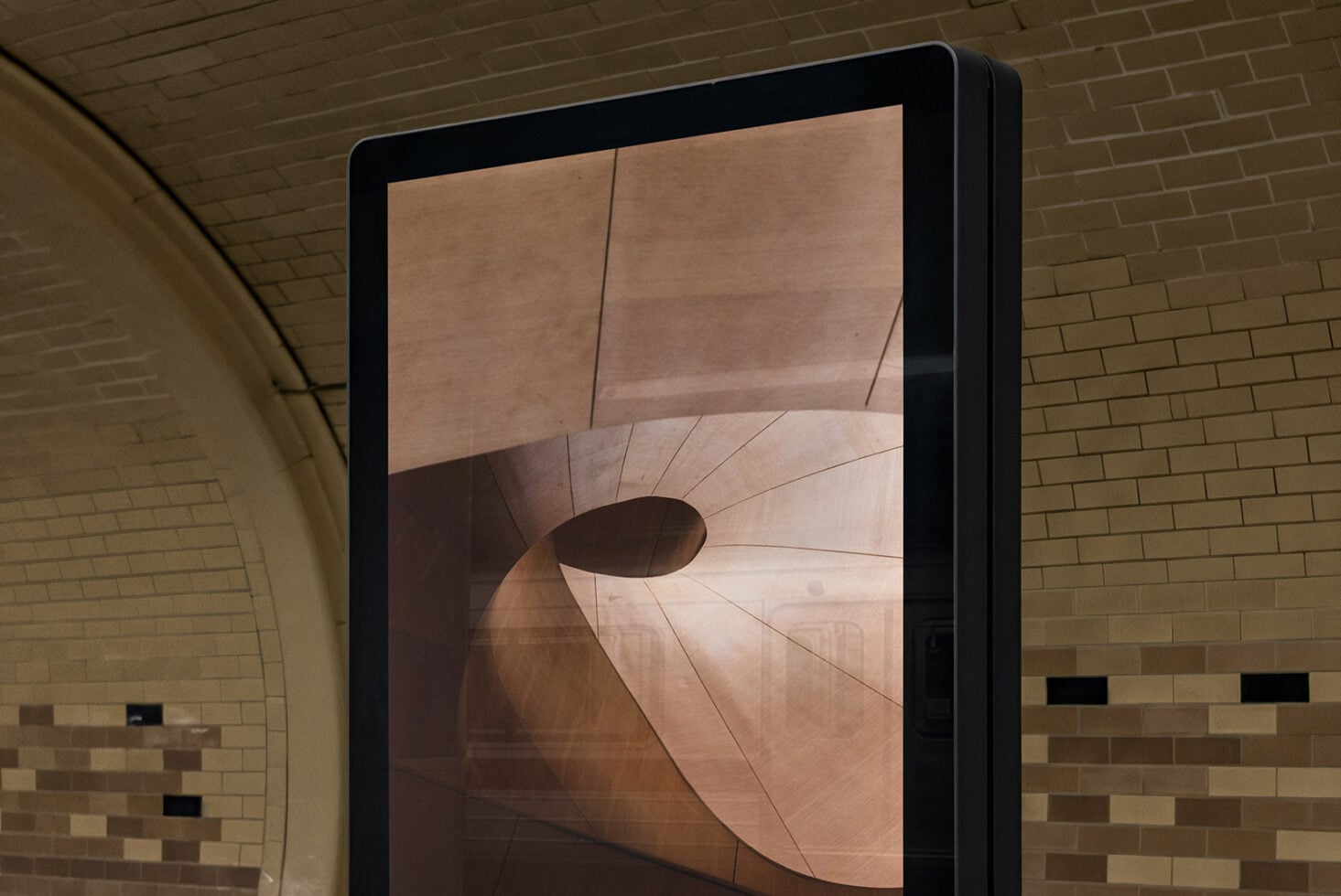 Indoor display screen showing warm toned abstract curved shapes mockup