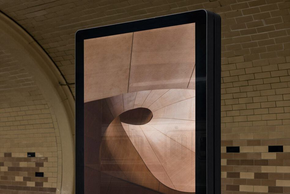 Indoor display screen showing warm toned abstract curved shapes mockup
