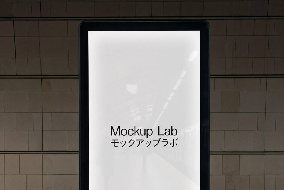 Black tablet on brick wall showing white screen with Mockup Lab text