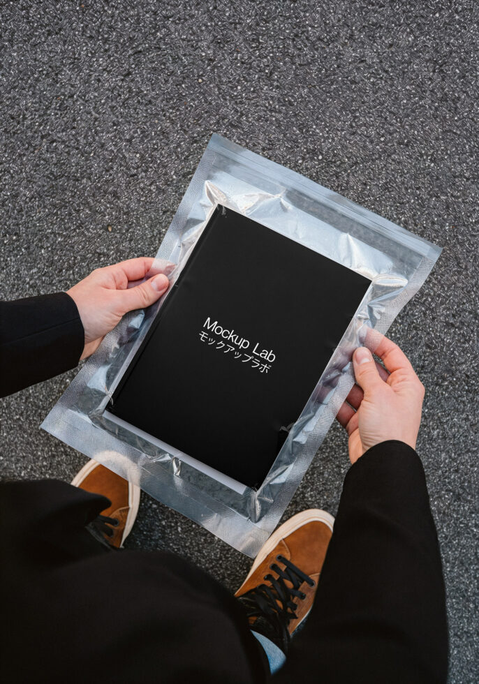 Tablet mockup in bubble wrap packaging overhead shot hands holding from both sides