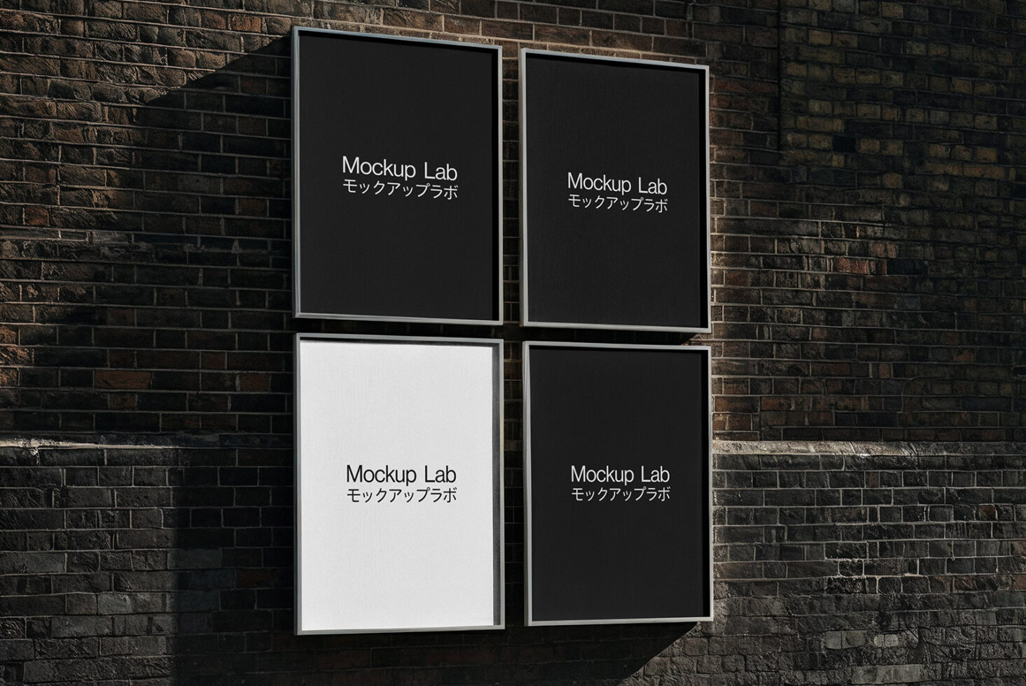 Four framed posters on brick wall with mixed black, white, grey backgrounds