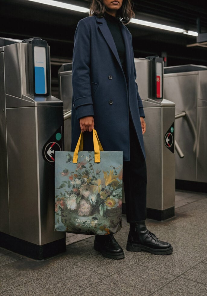 Woman in subway holding tote bag with floral botanical print design