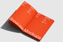 Two red folder mockups displayed open on neutral gray surface
