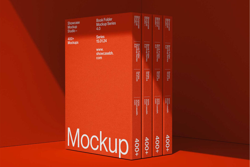 Group of four red books arranged at angles in red lit studio space
