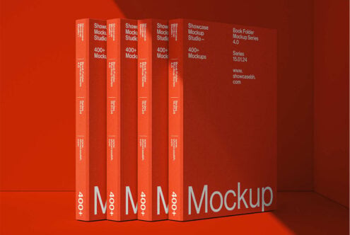 Row of red book spines with white text stacked on red surface studio shot