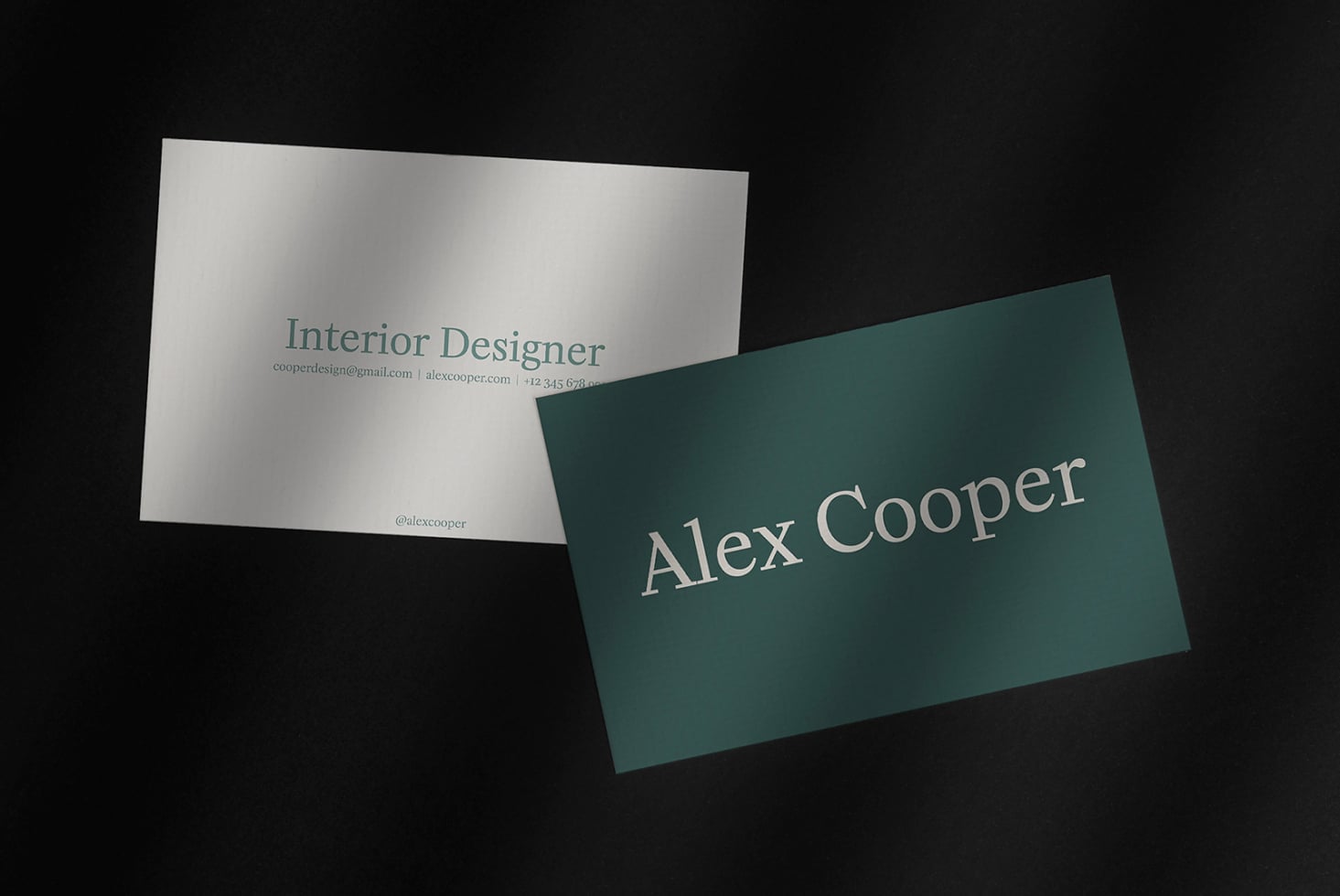 Two business cards overlapping showing cream reverse with contact details side