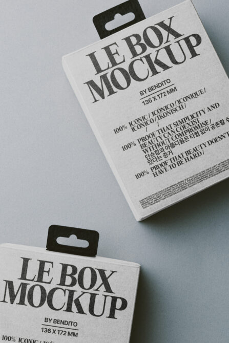 White boxes with black hang tabs stacked flat lay mockup