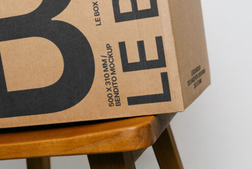 Natural kraft packaging mockup with bold black X on wooden base