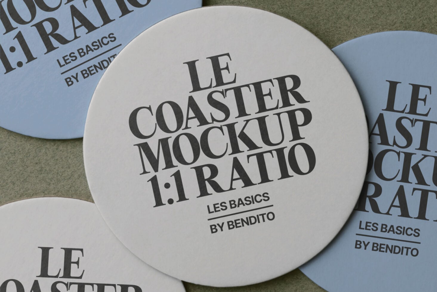 Cream circular coaster mockup displayed among blue versions on cloth surface