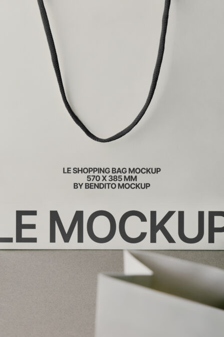 Black rope handles on cream background with Le Shopping Bag mockup text overlay