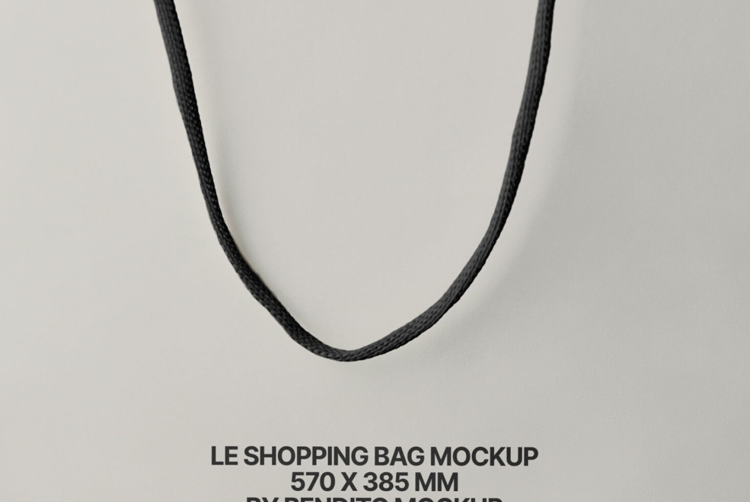 Minimalist shot of dark twisted rope handles suspended against neutral beige