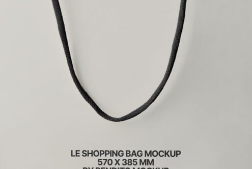 Minimalist shot of dark twisted rope handles suspended against neutral beige