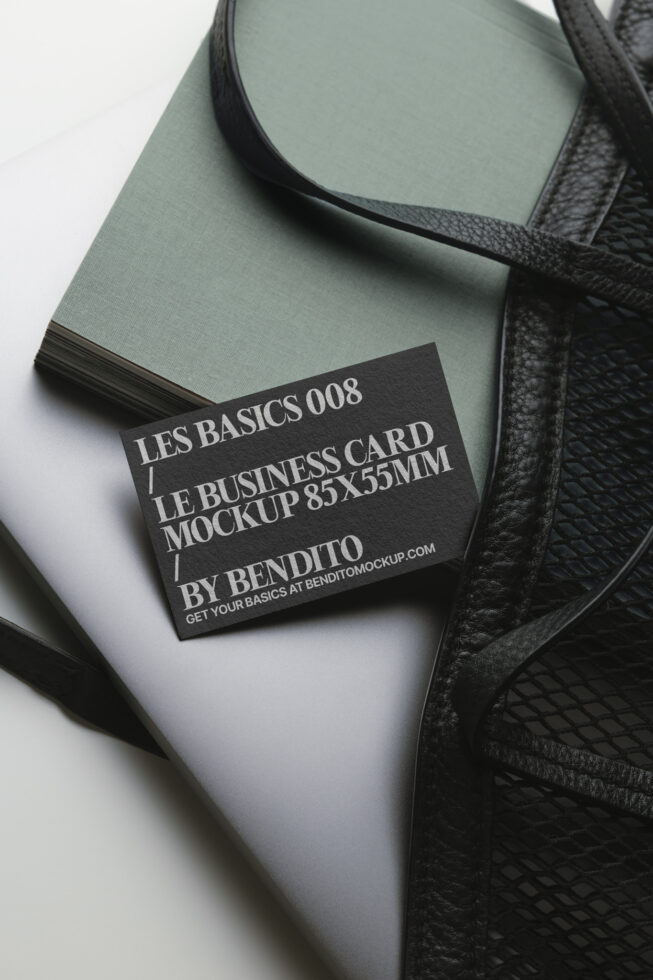 Dark business card mockup on seafoam notebook with black leather bag detail
