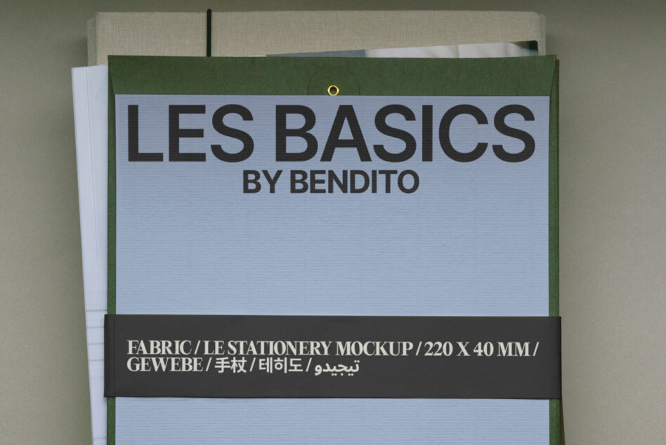 Fabric label mockup flat lay showing light blue panel, dark text band