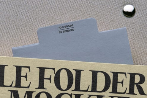 Folder design mockup with cream label text partially visible on textile background