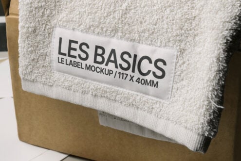 Cream folded towel with white label mockup, close-up of fabric texture on kraft box