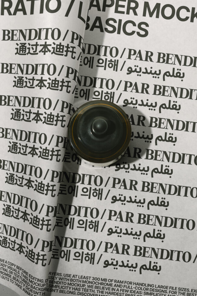 Rolled paper mockup with multilingual text on crumpled background, gold-rimmed black speaker on top