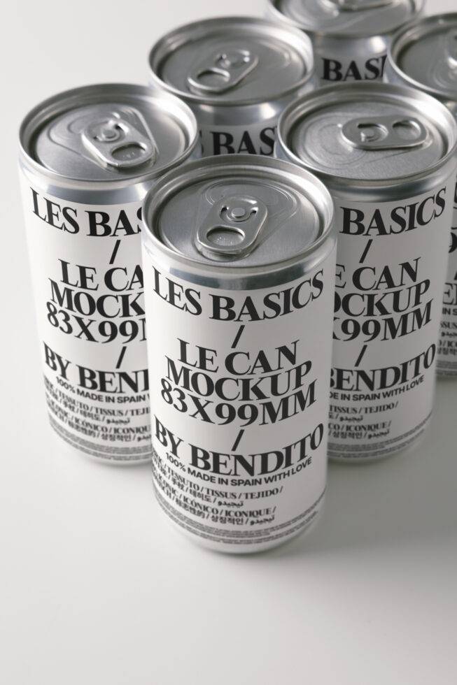 Close up of three beverage cans with pull ring tops, cream colored labels, black text overlay