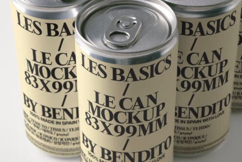 Angled view of aluminum cans with metallic finish, cream wrapping, bold sans serif branding