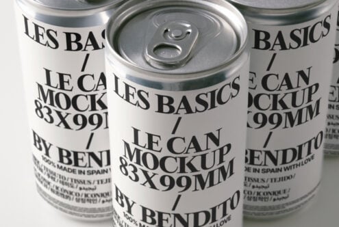 Three cans arranged showing pull tabs, cream labels with layered typography design