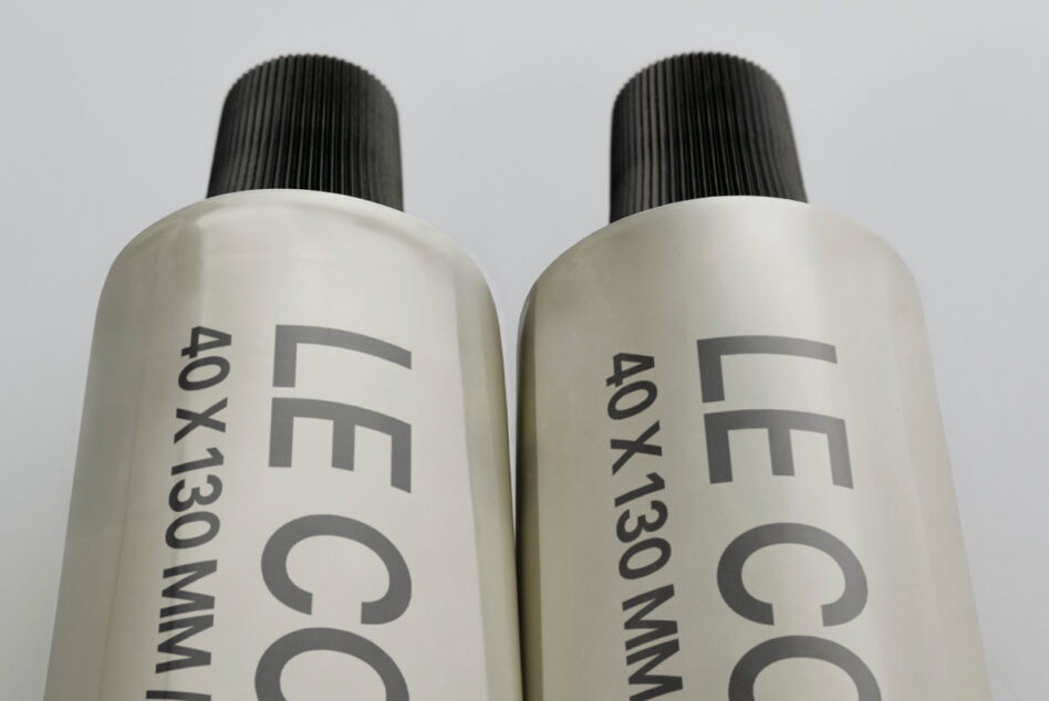Two off white cosmetic bottles with black pump dispensers side by side