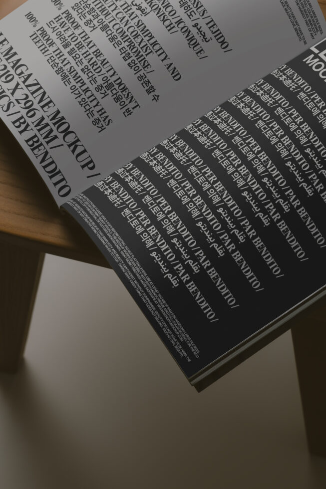 Open magazine spread with light gray page on dark background, tilted view