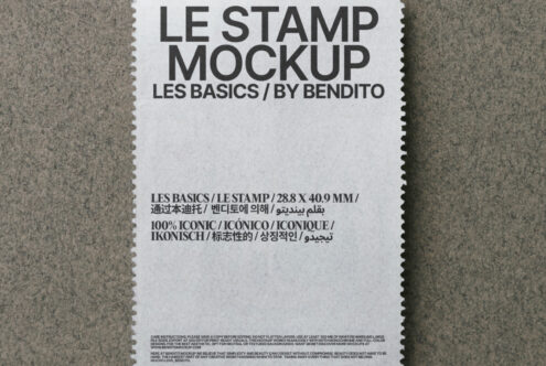 White stamp mockup with perforated edges on gray-green woven surface